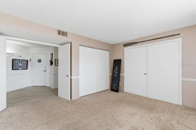a view of a livingroom with furniture and an empty room