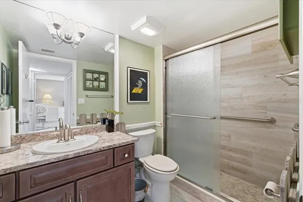 a bedroom with a bed and a lamp