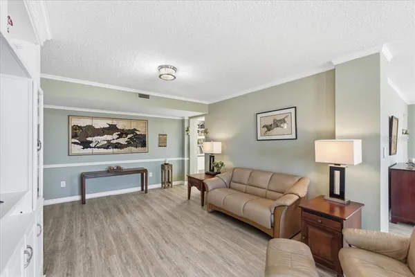 a living room with furniture or couch and a wooden floor