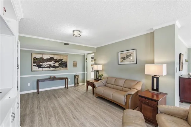 a living room with furniture or couch and a wooden floor