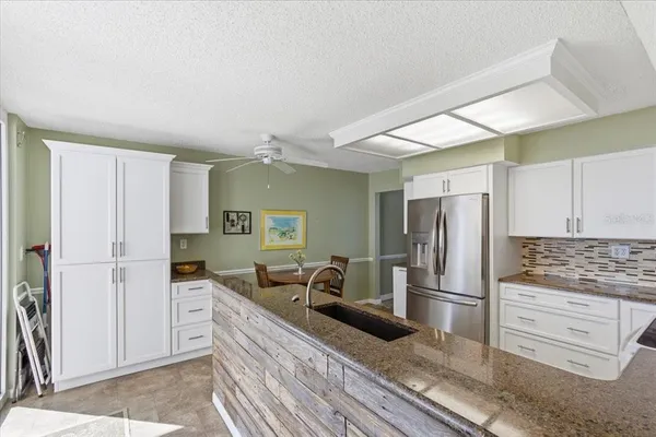a kitchen with a sink stove and cabinets