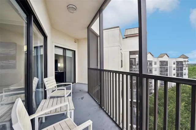a view of a balcony with chair and door