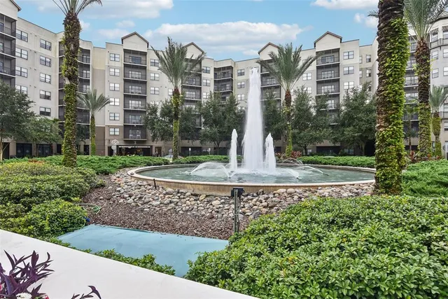 a front view of a multi story building with yard