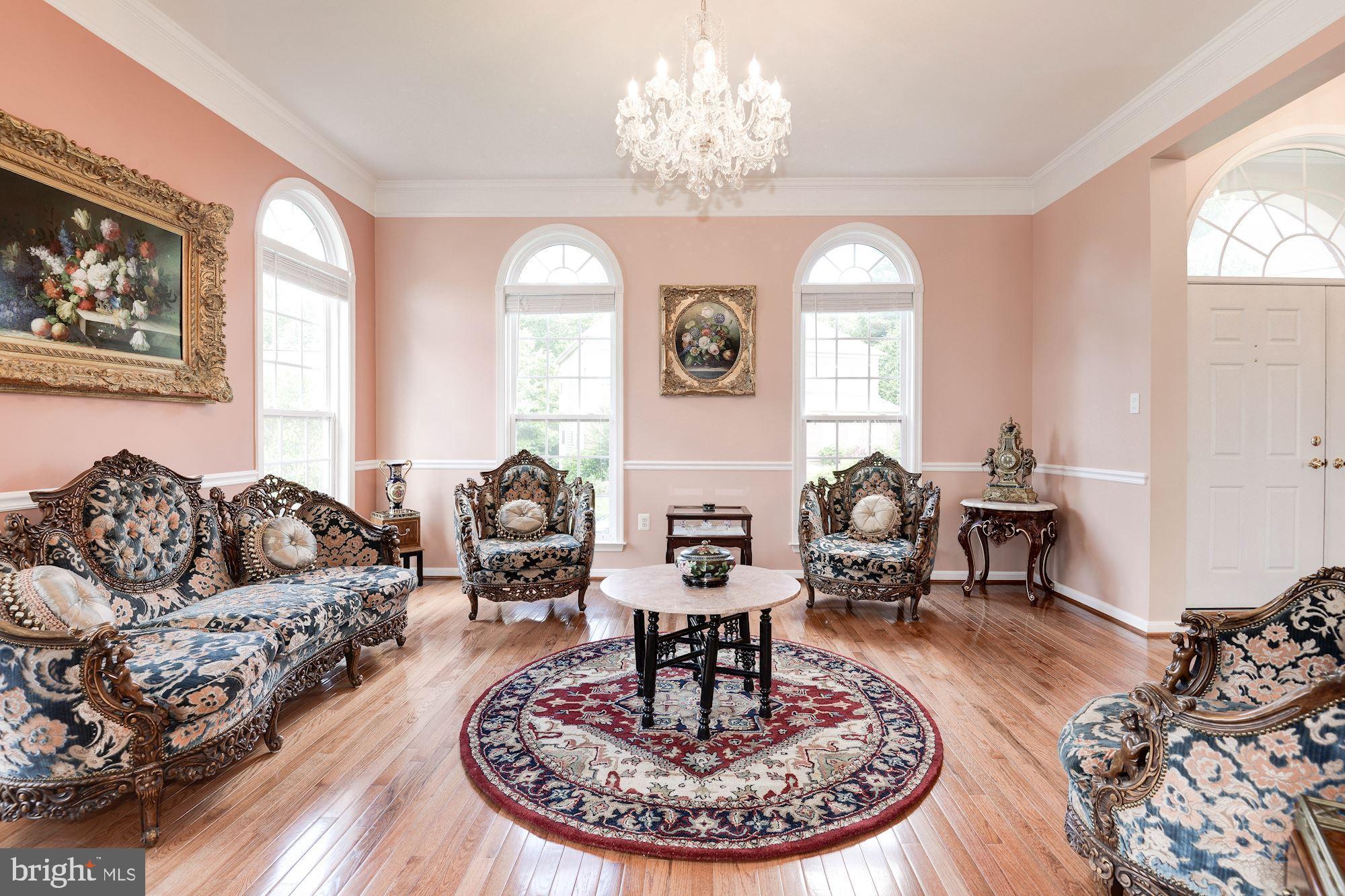 7104 Ayers Meadow Lane Springfield, VA 22150 - Photo 11 of 62 a living room with couches a fireplace and a dining table with garden view