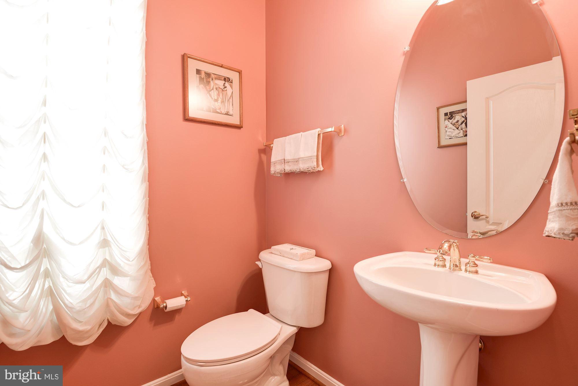 7104 Ayers Meadow Lane Springfield, VA 22150 - Photo 15 of 62 a bathroom with a sink mirror and a toilet