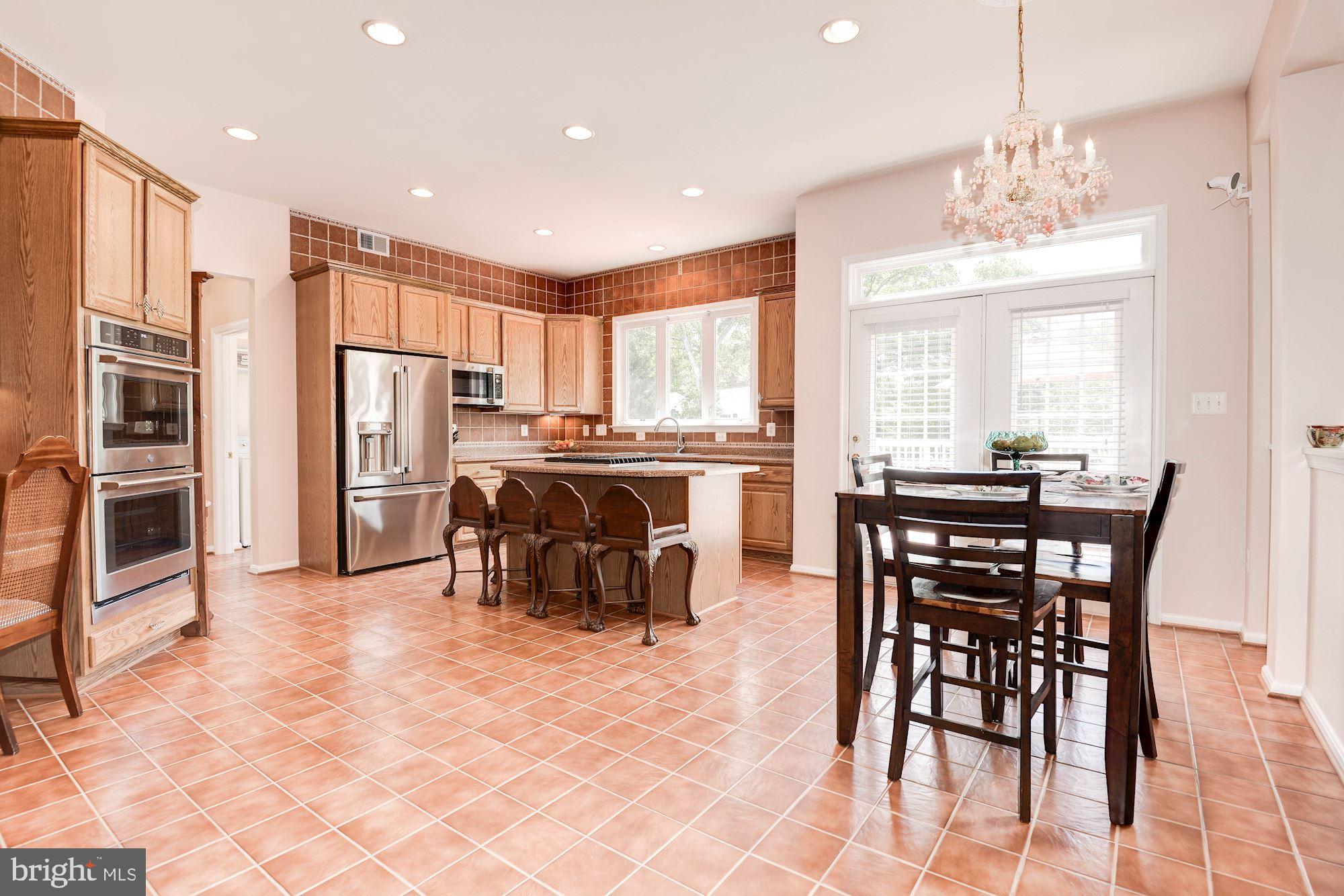 7104 Ayers Meadow Lane Springfield, VA 22150 - Photo 21 of 62 a view of a dining room with furniture and a chandelier