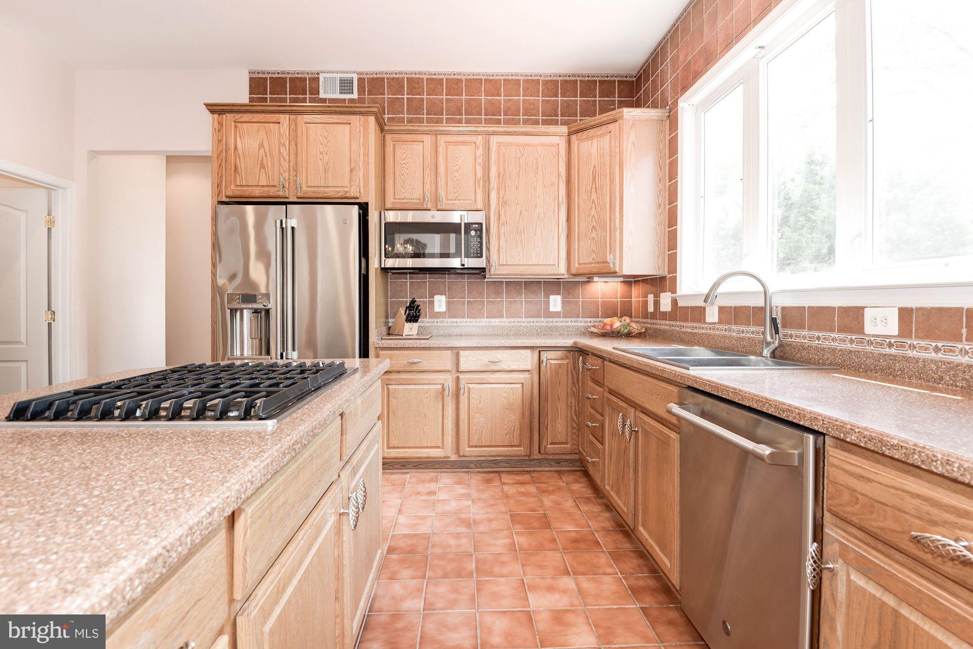 7104 Ayers Meadow Lane Springfield, VA 22150 - Photo 23 of 62 a kitchen with a sink a stove a refrigerator and a window