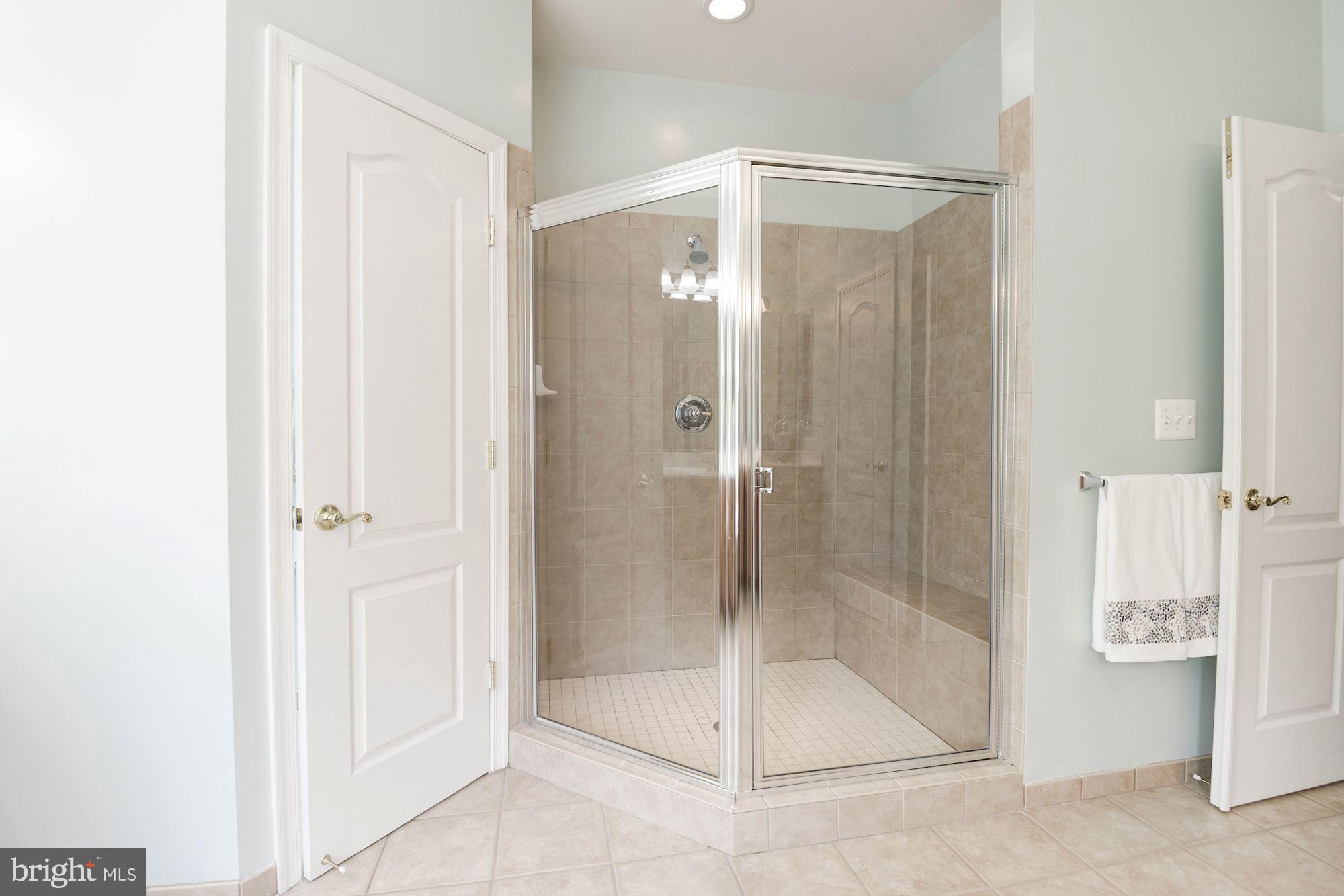 7104 Ayers Meadow Lane Springfield, VA 22150 - Photo 38 of 62 a bathroom with a glass shower door