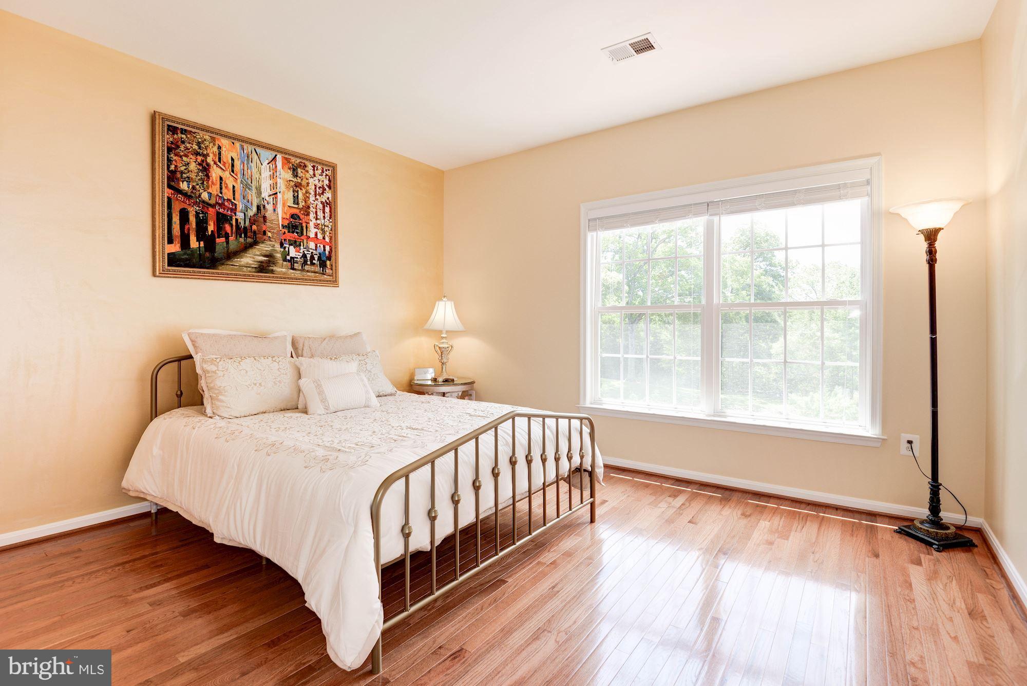 7104 Ayers Meadow Lane Springfield, VA 22150 - Photo 39 of 62 a bedroom with a bed and a large window