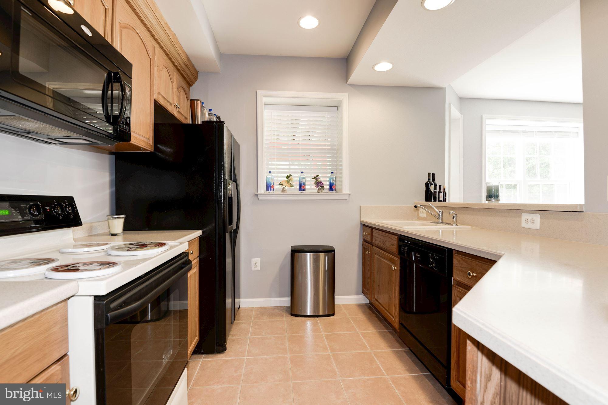 7104 Ayers Meadow Lane Springfield, VA 22150 - Photo 48 of 62 a kitchen with stainless steel appliances granite countertop a sink stove and refrigerator