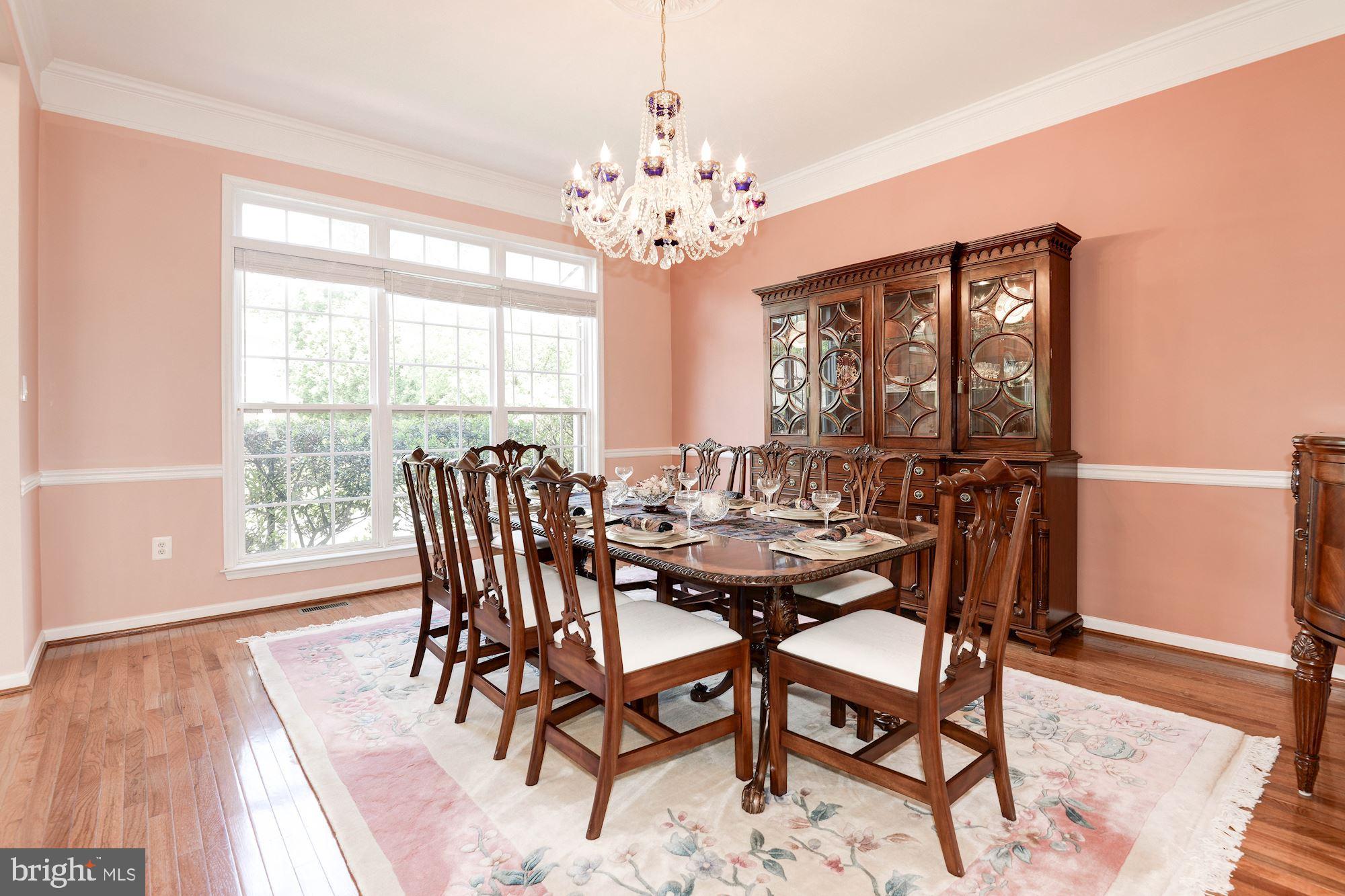 7104 Ayers Meadow Lane Springfield, VA 22150 - Photo 8 of 62 a view of a dining room with furniture wooden floor and chandelier