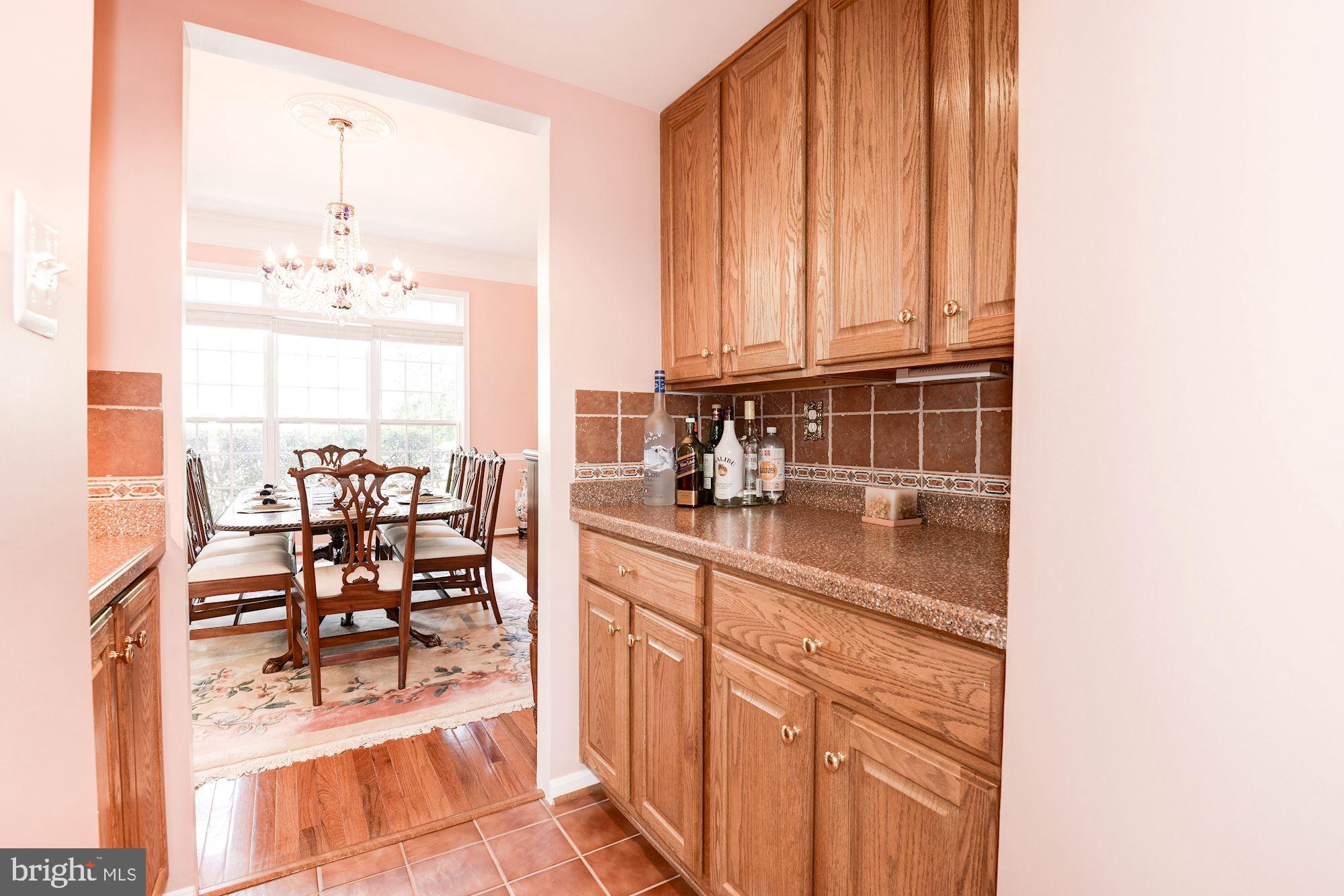 7104 Ayers Meadow Lane Springfield, VA 22150 - Photo 9 of 62 a kitchen with granite countertop a sink and a refrigerator