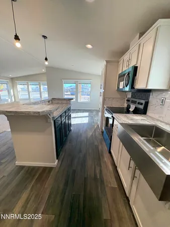 a kitchen with a sink stove and cabinets