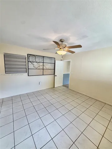 a view of a livingroom with an empty space and a window