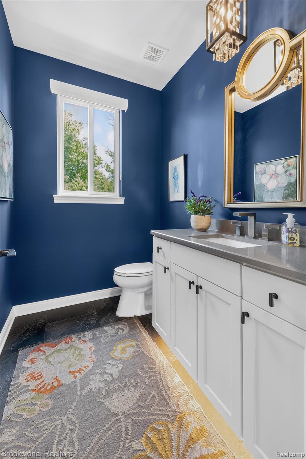 2167 Sanctuary Court Rochester, MI 48309 - Photo 39 of 68 Bathroom featuring a white vanity with panel cabinetry and dark hardware, set against deep blue walls