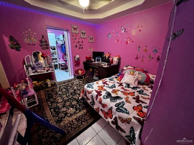 708 Paisano Street Sullivan City, TX 78595 - Photo 6 of 9 Bedroom featuring ceiling fan, light tile patterned floors, and a raised ceiling