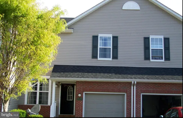 a view of a house with a tree