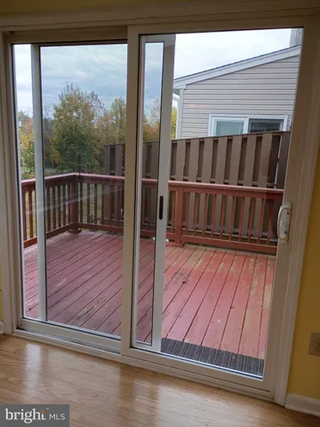 a view of a balcony with wooden floor