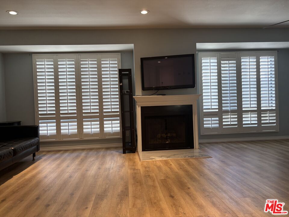 557 East Verdugo Avenue, Unit C Burbank, CA 91501 - Photo 13 of 14 a view of empty room with fireplace and wooden floor