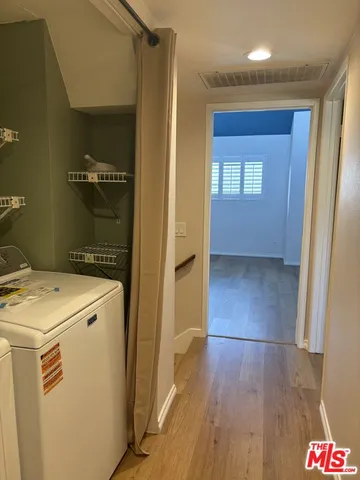 a view of hallway with wooden floor