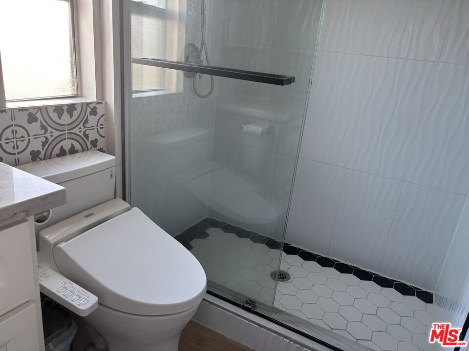 557 East Verdugo Avenue, Unit C Burbank, CA 91501 - Photo 6 of 14 a bathroom with a toilet and a shower curtain