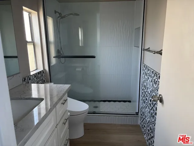 a bathroom with a toilet and a shower