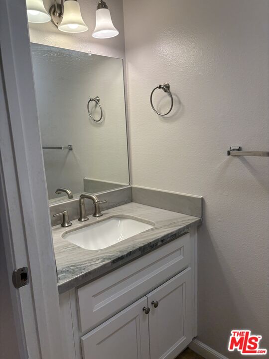 557 East Verdugo Avenue, Unit C Burbank, CA 91501 - Photo 10 of 14 a bathroom with a granite countertop sink and a mirror