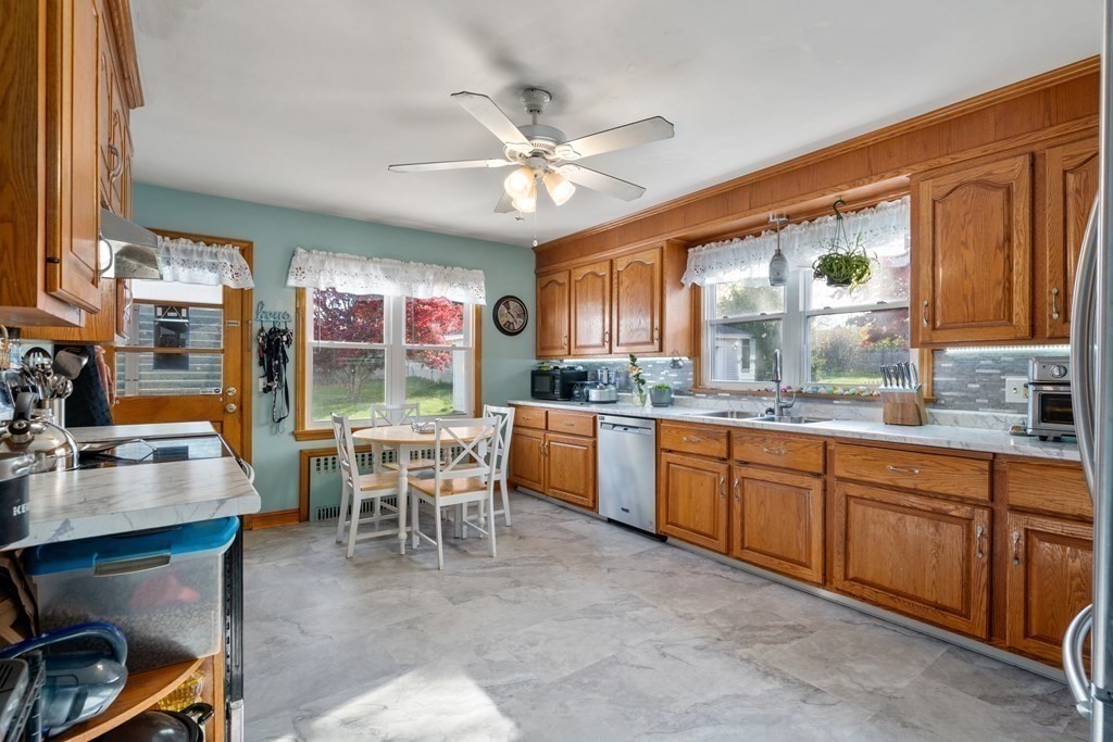 45 Ruggles Street Three Rivers, MA 01080 - Photo 12 of 29 a dining room with stainless steel appliances granite countertop furniture a fireplace and a window