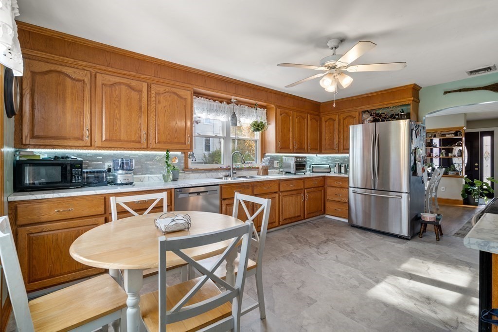 45 Ruggles Street Three Rivers, MA 01080 - Photo 13 of 29 a kitchen with stainless steel appliances granite countertop a refrigerator a sink a stove a dining table and chairs