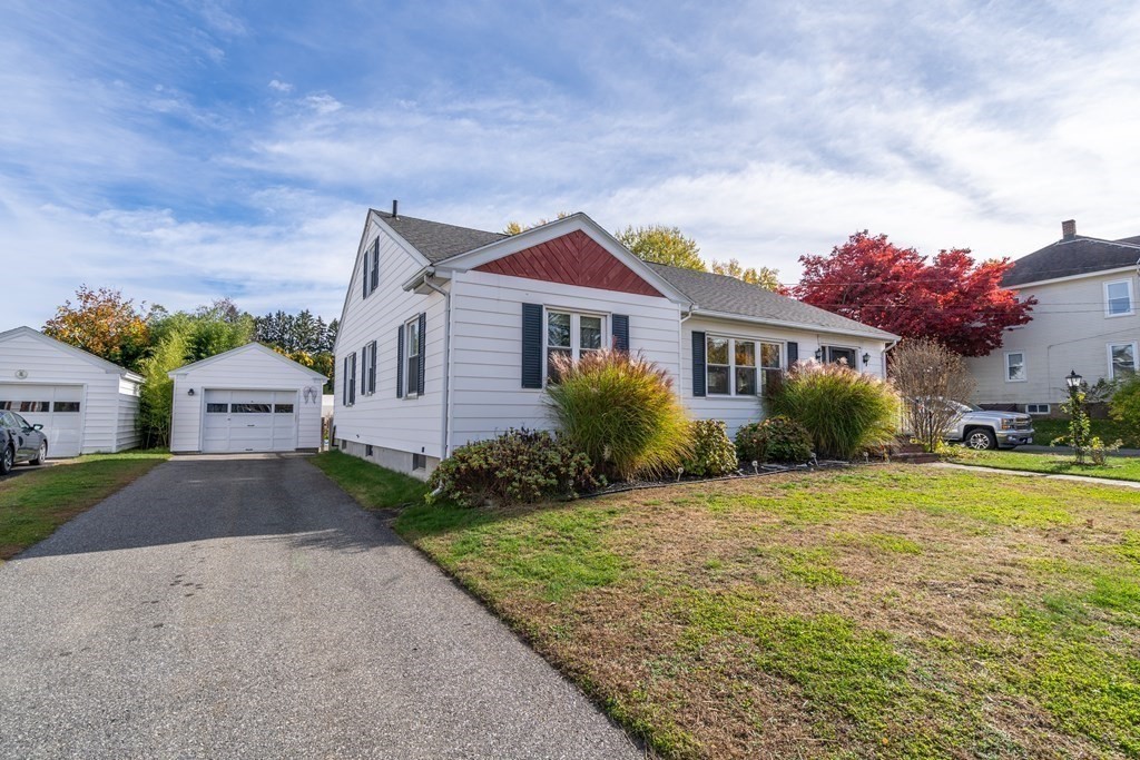 45 Ruggles Street Three Rivers, MA 01080 - Photo 3 of 29 a front view of a house with a yard and garage