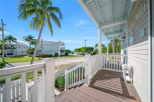 a view of balcony with wooden floor and fence