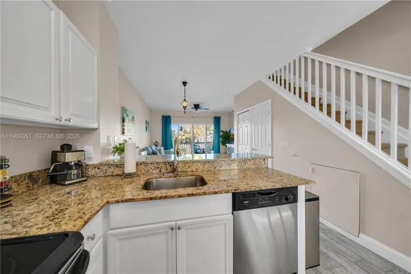a kitchen with sink cabinets and window