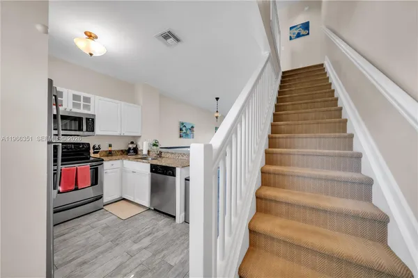 a view of kitchen with sink and microwave