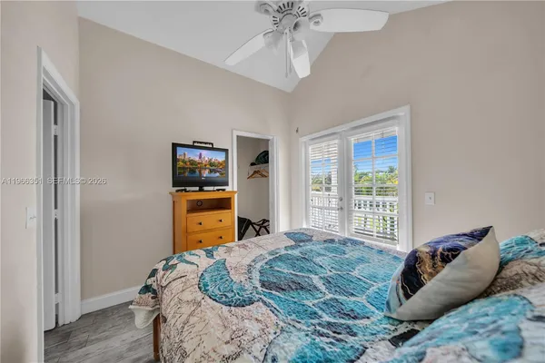 a bedroom with a bed and a flat tv screen
