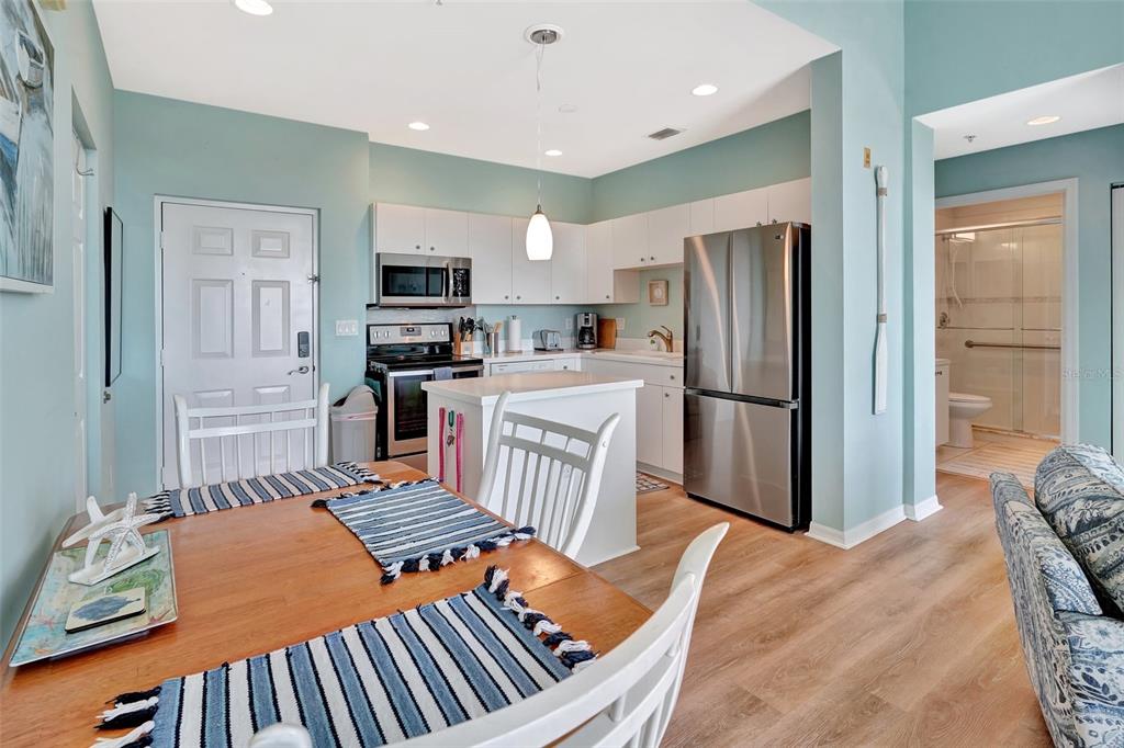2090 Matecumbe Key Road, Unit 1708 Punta Gorda, FL 33955 - Photo 14 of 34 a kitchen with stainless steel appliances granite countertop a refrigerator oven a sink dishwasher and a stove with a dining table