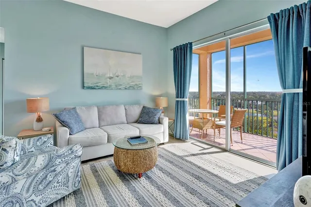 a living room with furniture a lamp and a floor to ceiling window