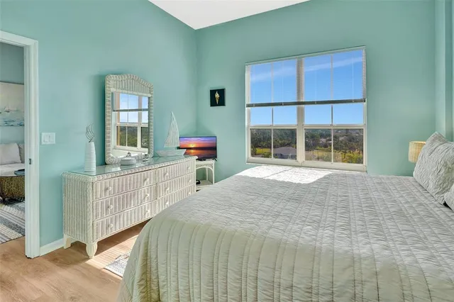 a bed sitting in a bedroom next to a window