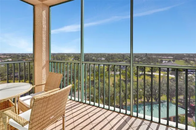 a roof deck with table and chairs and wooden floor