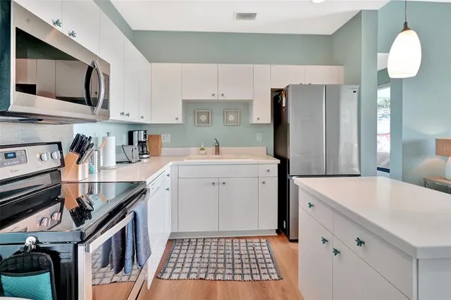 a kitchen that has a sink and a stove in it