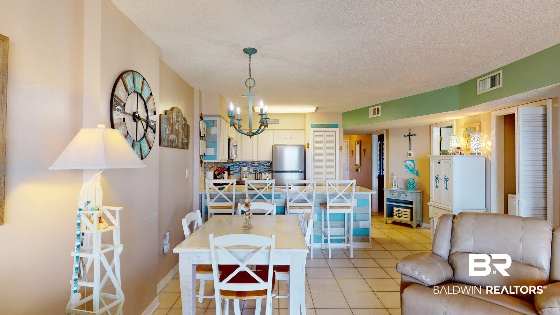 645 Plantation Road, Unit 6503 Gulf Shores, AL 36542 - Photo 19 of 53 Dining area featuring light tile patterned flooring, a chandelier, and a textured ceiling
