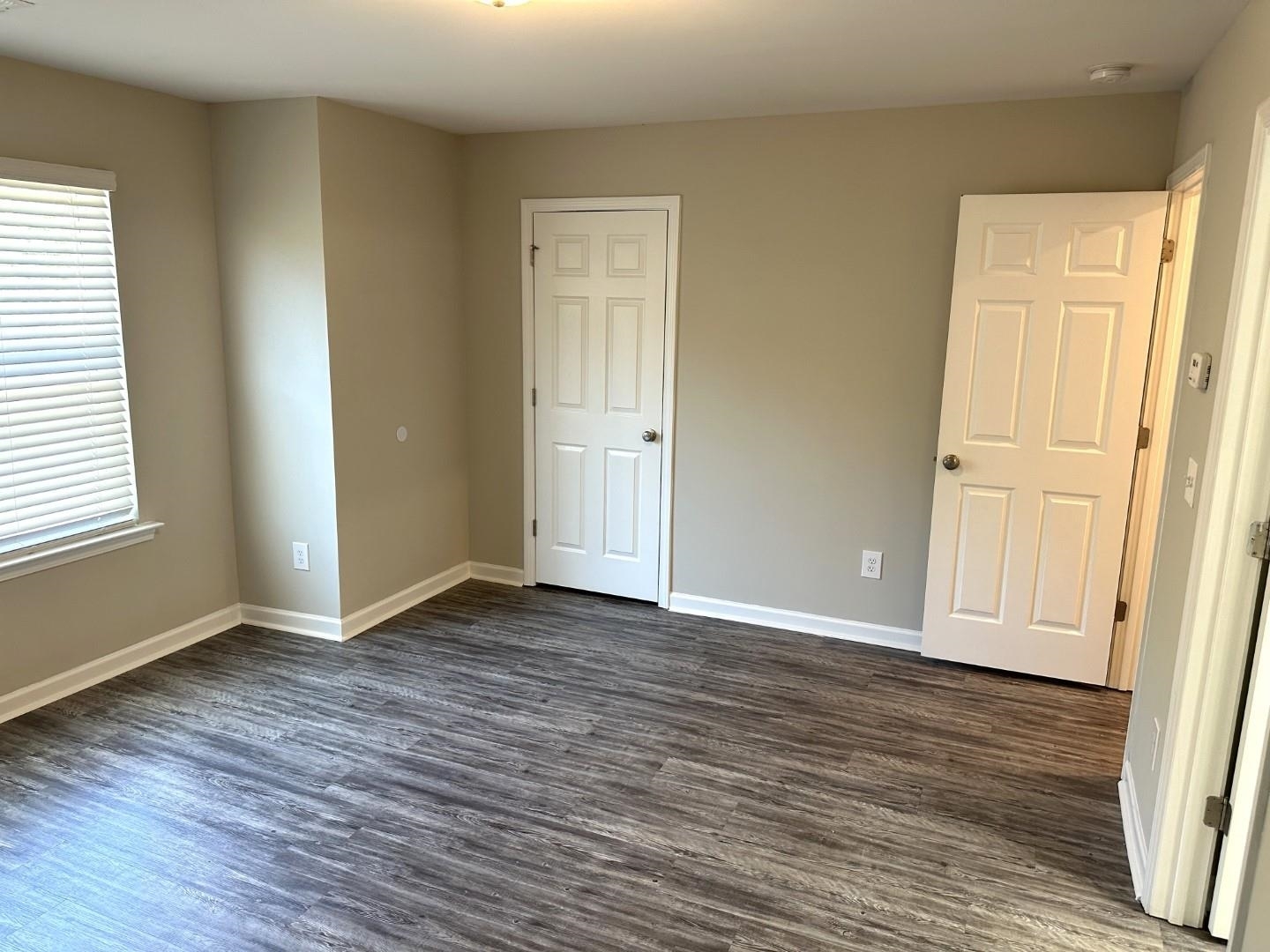 712 Keeshono St Union, Unit 712 Union City, GA 30291 - Photo 15 of 22 an empty room with wooden floor and windows