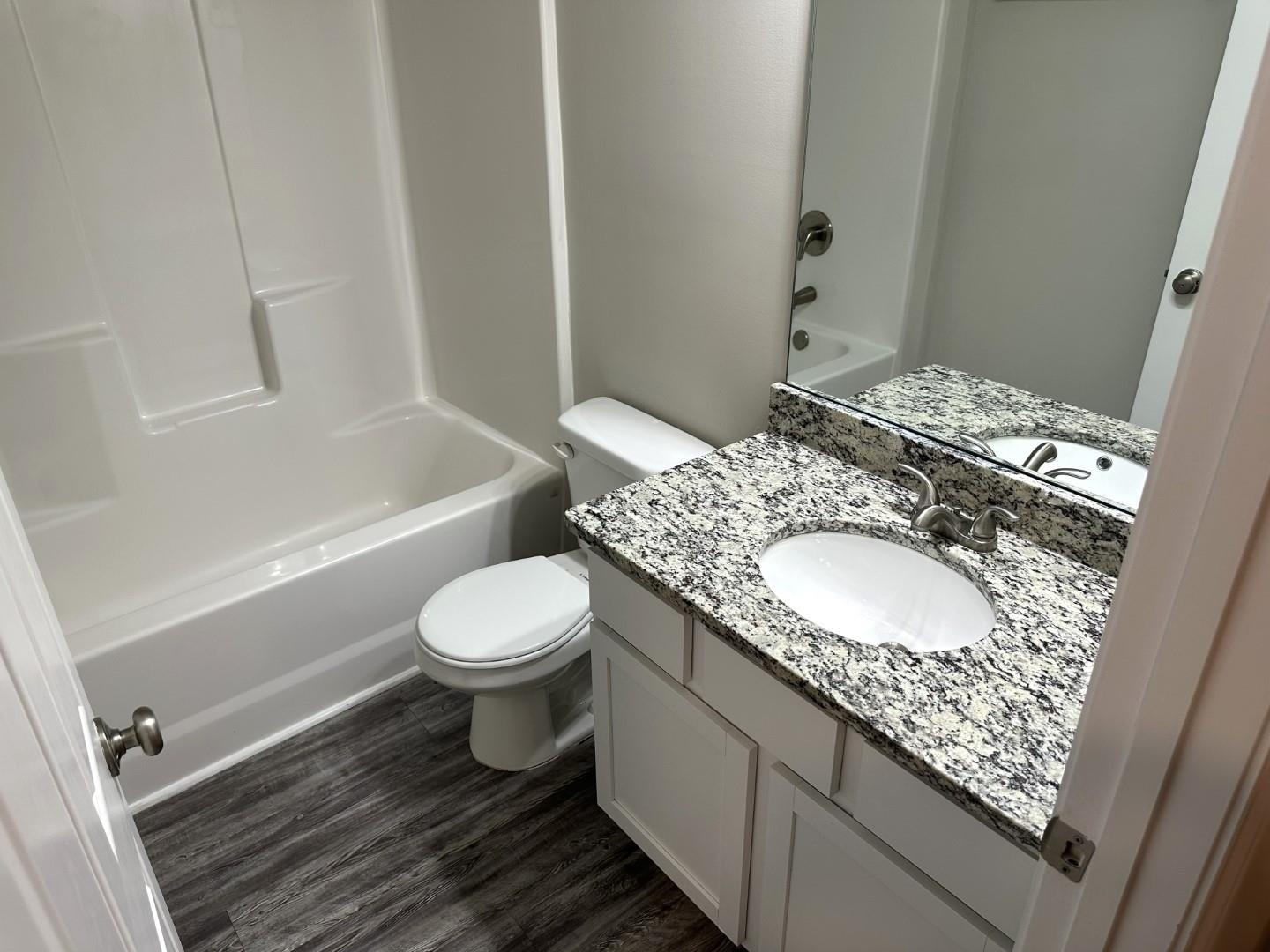 712 Keeshono St Union, Unit 712 Union City, GA 30291 - Photo 18 of 22 a bathroom with a granite countertop sink toilet and shower