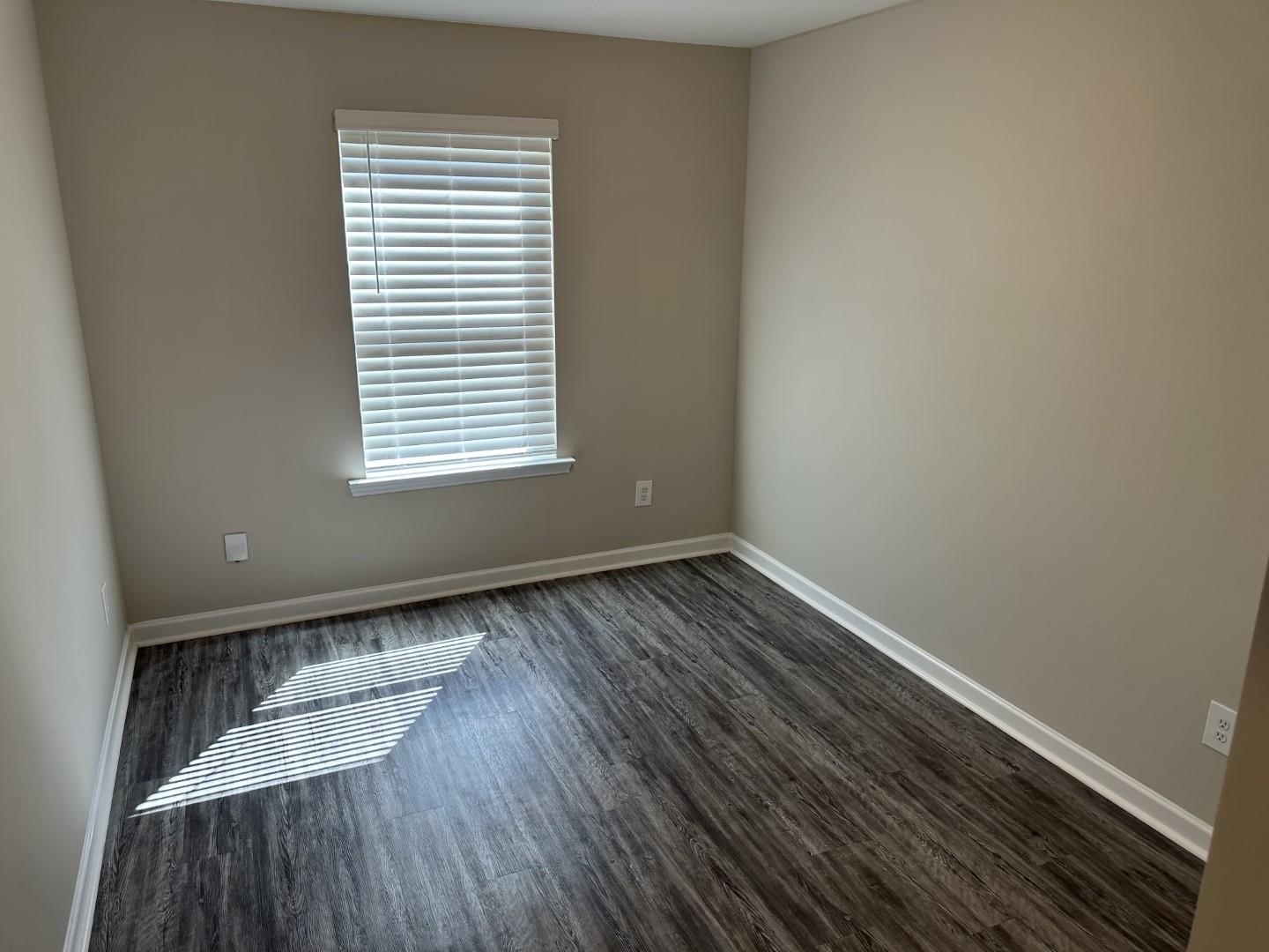 712 Keeshono St Union, Unit 712 Union City, GA 30291 - Photo 19 of 22 a view of an empty room with wooden floor and a window