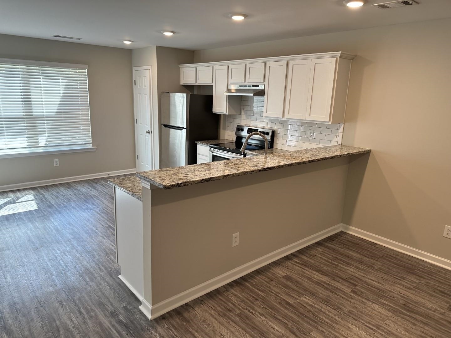 712 Keeshono St Union, Unit 712 Union City, GA 30291 - Photo 6 of 22 a kitchen with stainless steel appliances granite countertop a sink a stove a refrigerator and cabinets