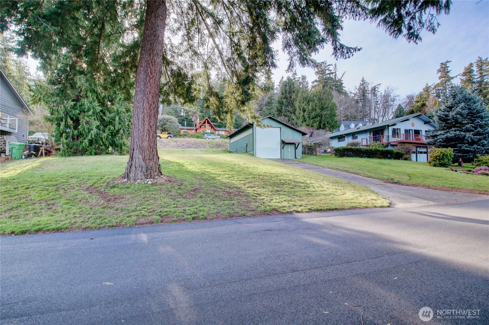 4116 Mitchell Drive Anacortes, WA 98221 - Photo 25 of 39 a house with trees in front of it