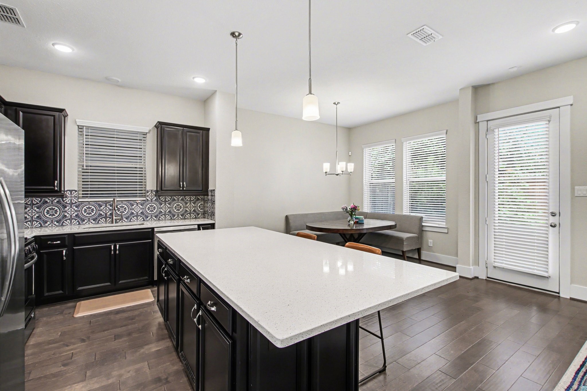 2007 Tarfite Place Houston, TX 77077 - Photo 5 of 24 a kitchen with a stove a sink dishwasher a kitchen island with wooden cabinets and floor