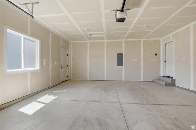 730 West 500 North Smithfield, UT 84335 - Photo 32 of 46 Spacious garage featuring a concrete floor, window, and a door with concrete steps