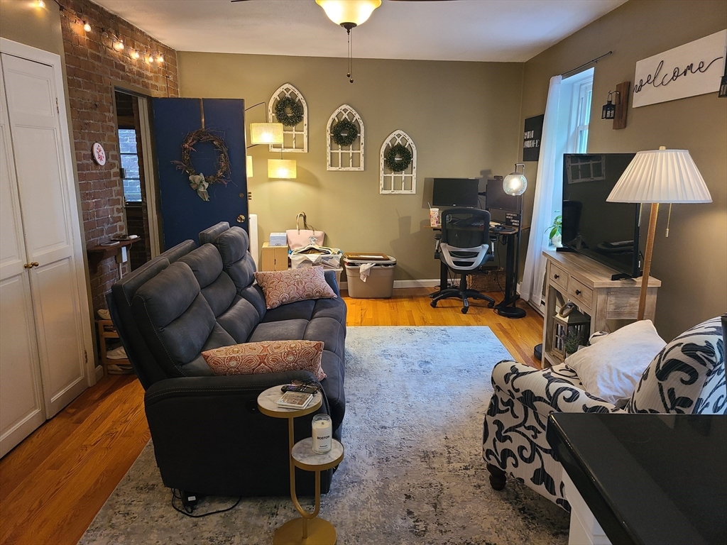 32 Fleet Street, Unit 5 Boston, MA 02113 - Photo 7 of 12 a living room with furniture and a lamp