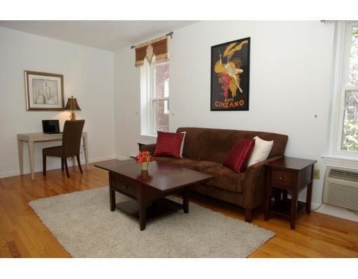 32 Fleet Street, Unit 5 Boston, MA 02113 - Photo 8 of 12 a living room with furniture a desk and chair with potted plant