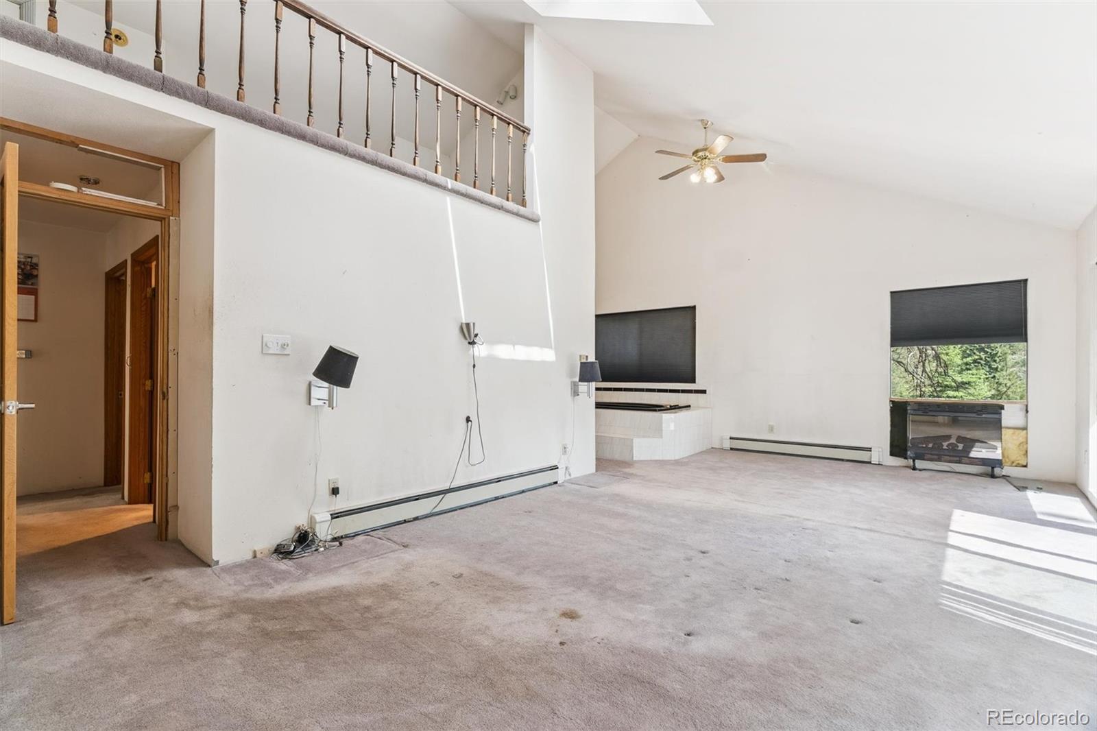 3909 County Road 72 Bailey, CO 80421 - Photo 11 of 50 an empty room with windows and a flat screen tv